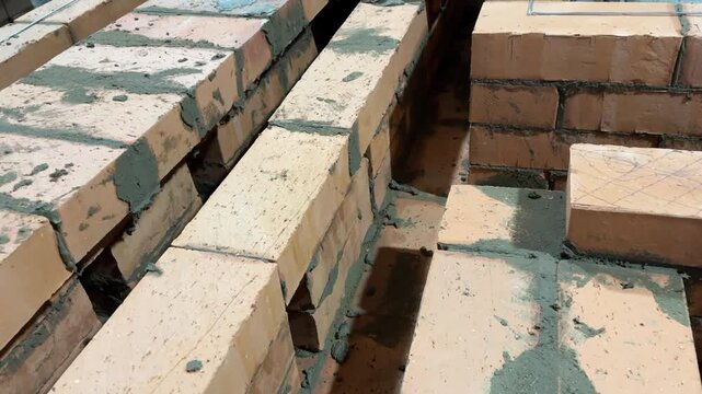 Fresh brickwork of a heating stove ash pit and bench. Smoke channels of the bench are visible. Close-up.