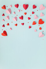 Valentine or Mother's Day frame blue vertical background with red hearts top view. Festive mockup...