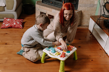 Mother and Son Playing with Toys on the Floor