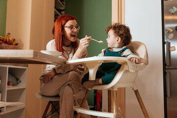 Mother and Son Enjoying a Meal Together in the Kitchen
