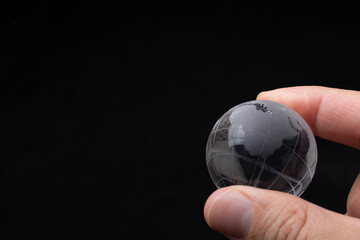 World globe crystal glass in hand.  Global business and economy. Environmental or ecology concept