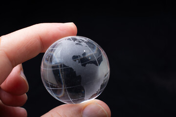 World globe crystal glass in hand.  Global business and economy. Environmental or ecology concept
