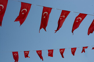 Turkish national flag with crescent and star hang on a pole.