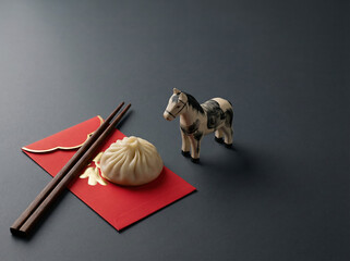 Lunar New Year Still Life with Red Envelope, Dumpling, and Horse Figurine