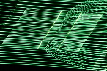 A long exposure photograph. Light painting photography, vibrant green fairy lights in an electric, technical parallel lines pattern against a black background