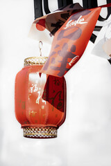 Red fabric chinese lantern hanging above porch on white background, copy space