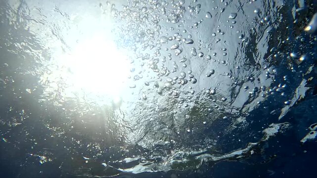 Underwater view of sunlight through clear water in daytime