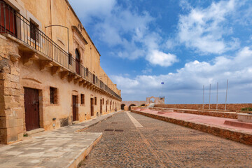 Stone walls and entrance of historic Firkas Fortress in Chania, Crete, Greece under blue sky