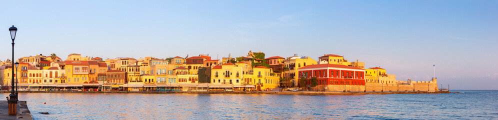 Colorful buildings along the Venetian Harbor waterfront at sunrise in Chania, Crete, Greece