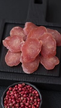 Sliced smoked dry sausage made from turkey or pork for breakfast sandwiches. Sliced smoked sausage as a food background for your design