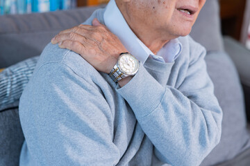 Elderly man grab his shoulder suffer from shoulder pain
