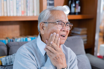 Elderly man grab his cheek suffer from toothache