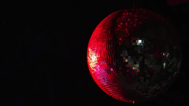 Party disco mirror ball reflecting colorful lights at night celebration event