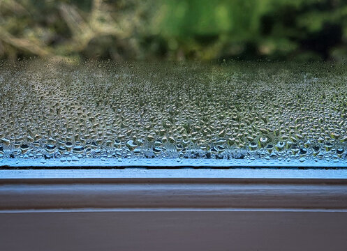 Condensation on inside of window glass in home showing moisture and heat loss caused by cold weather and poor insulation