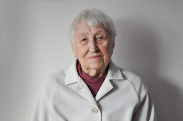 Head shot close up portrait thoughtful middle aged retired woman worrying about personal health problems. Upset older female retiree thinking of family troubles, feeling lonely, sitting at home.