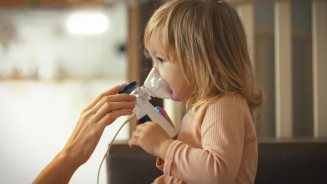A mother mentors her child on using a nebulizer for effective inhalation therapy, promoting health and relief from cold-induced mucus in the bronchi. This educational moment highlights a parent's care