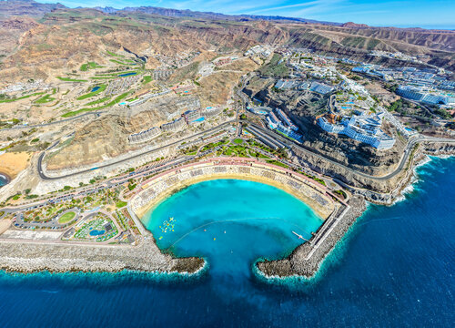 Aerial view of Playa de Amadores Beach and Cliffside 5-Star Resorts, featuring Gloria Palace and RIU Vistamar, Gran Canaria, Spain
