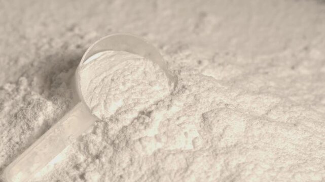 super slow motion Closeup of powder spilling from scoop, Product shot highlighting purity and measurement