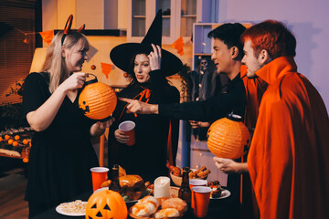 Friends enjoying a Halloween party at a bar making a toast