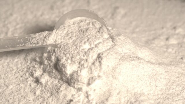 super slow motion Highdefinition cinematic portrayal of powder particles dispersing as supplement scoop breaks