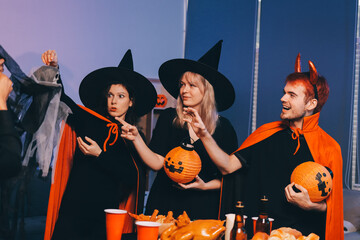 Friends enjoying a Halloween party at a bar making a toast