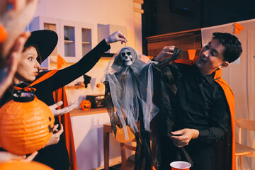Friends enjoying a Halloween party at a bar making a toast
