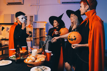 Friends enjoying a Halloween party at a bar making a toast