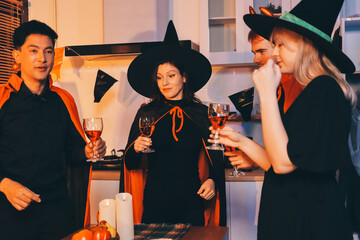 Friends enjoying a Halloween party at a bar making a toast