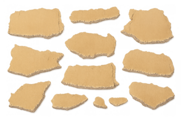 Torn brown cardboard pieces with rough edges, ripped paper fragments, and textured scraps on transparent background