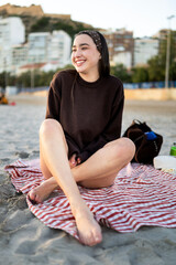 Young girl relaxing and smiling on winter beach