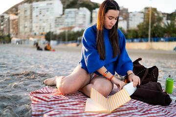 Young woman enjoying mindful winter beach relaxation