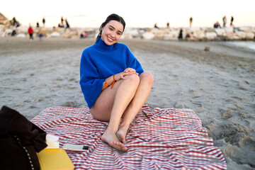 Young woman enjoying beach relaxation in winter