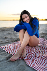 Young woman enjoying mindful winter beach sunset
