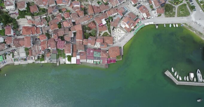 Aerial view of Ohrid. Different sail boats beside dock on ohrid lake with traditional house architecture on background