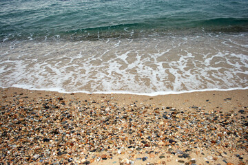 Stunning serene relaxing sandy beach with waves, travel themes.