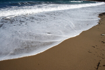 Stunning serene relaxing sandy beach with waves, travel themes.