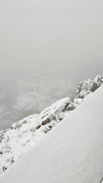 Winter view from a steep mountain slope in Ostrog, Montenegro with low visibility