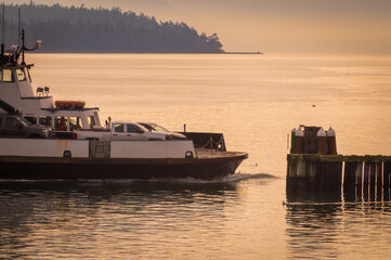 The ferryboat, Whatcom Chief, prepares to dock at the Lummi Island ferry landing during sunrise. This ferryboat has been running for over 60 years between the island and Gooseberry Point mainland.