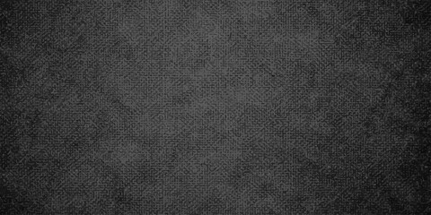 A closeup of a dark black leather texture background with a rough grunge pattern on a blank material surface for a textile wallpaper backdrop