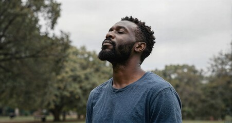 Black man meditating outdoors connecting with nature for peace