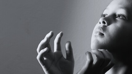little boy praying to God with hands together with people stock image stock photo