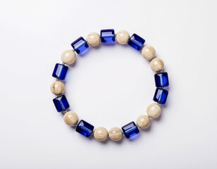 Obraz premium Blue and Beige Beaded Bracelet on White.