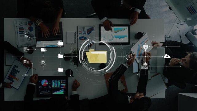 A dynamic business team engages in data analysis using digital devices in a collaborative office setting, focusing on charts and strategic discussions for effective outcomes. Raster