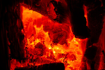 Glowing hot embers burning inside a fireplace