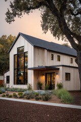Modern house design with large windows surrounded by trees and plants during evening light in a residential neighborhood