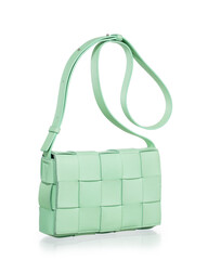 A modern, minimalist green woven leather bag set against a white background with highlights.