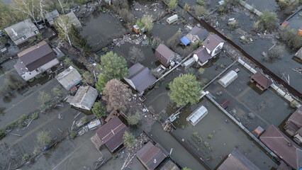 Aerial drone footage of a massive city flood with houses and streets submerged under water. Urban flooding caused by extreme weather and heavy rainfall, showing natural disaster impact on residential 