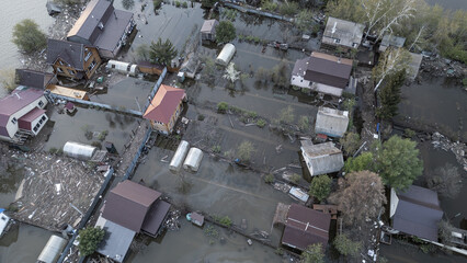 Aerial drone footage of a massive city flood with houses and streets submerged under water. Urban flooding caused by extreme weather and heavy rainfall, showing natural disaster impact on residential 
