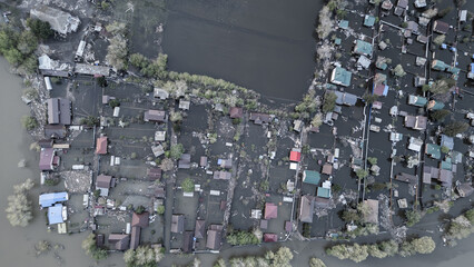 Aerial drone footage of a massive city flood with houses and streets submerged under water. Urban flooding caused by extreme weather and heavy rainfall, showing natural disaster impact on residential 