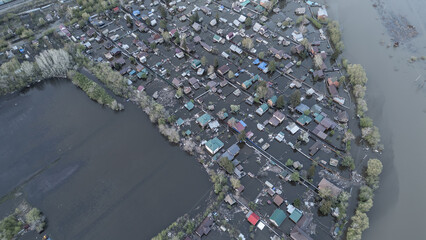Aerial drone footage of a massive city flood with houses and streets submerged under water. Urban flooding caused by extreme weather and heavy rainfall, showing natural disaster impact on residential 